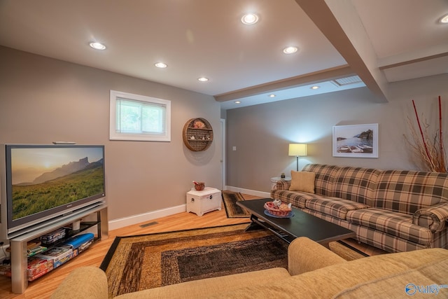 living area featuring wood finished floors, beamed ceiling, baseboards, visible vents, and recessed lighting