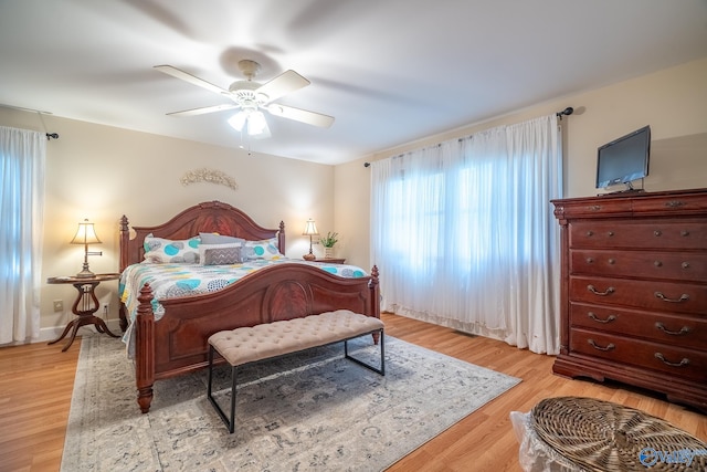 bedroom with light wood-type flooring and a ceiling fan