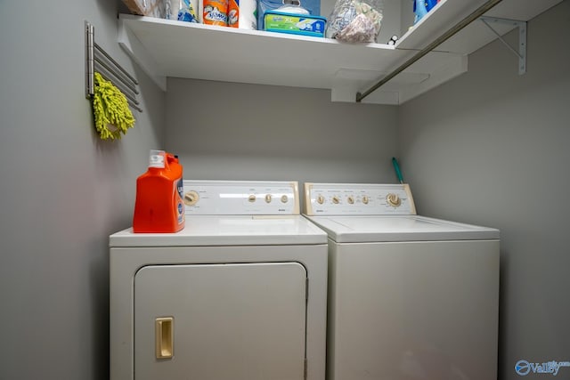clothes washing area with washer and clothes dryer and laundry area