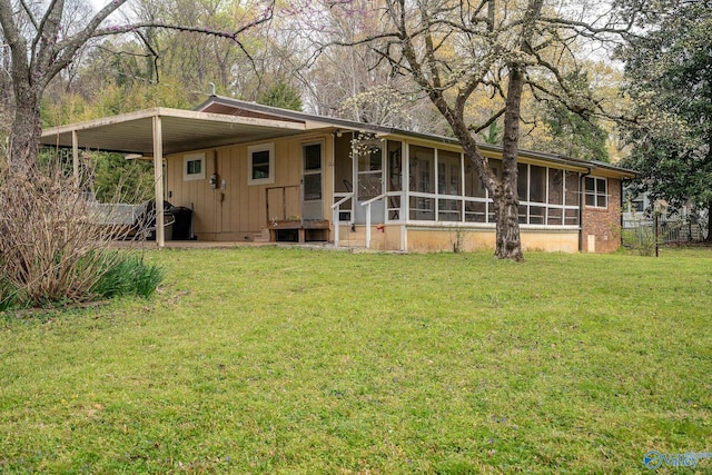 view of front facade with a sunroom, a front lawn, and board and batten siding