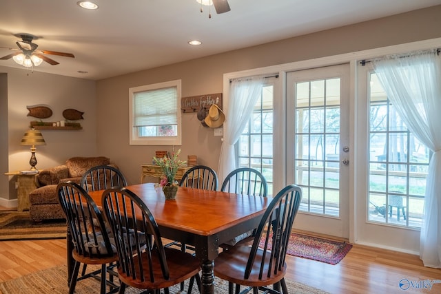 dining area with a wealth of natural light, light wood-type flooring, and a ceiling fan