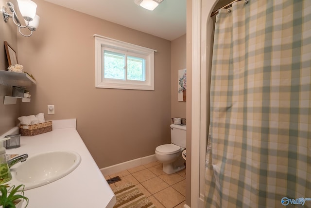 bathroom featuring baseboards, toilet, tile patterned floors, a shower with curtain, and a sink