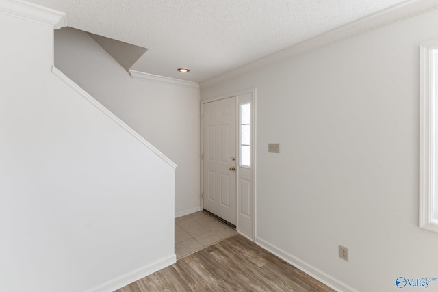 entrance foyer with wood finished floors, baseboards, and a textured ceiling