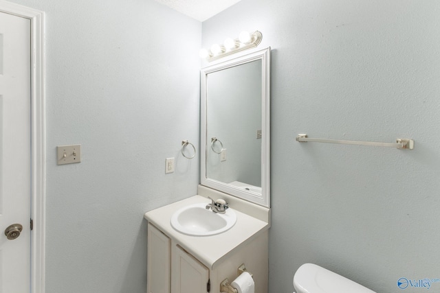 bathroom with toilet and vanity