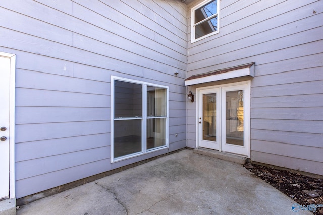 view of exterior entry with a patio