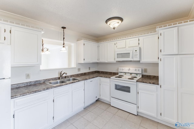 kitchen featuring white appliances, light tile patterned floors, a sink, white cabinets, and dark countertops