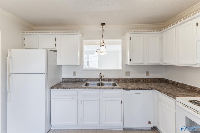 kitchen featuring dark countertops, white cabinets, white appliances, and a sink