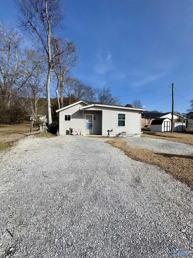 view of front of home with a storage shed