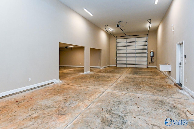 garage featuring a garage door opener and baseboards