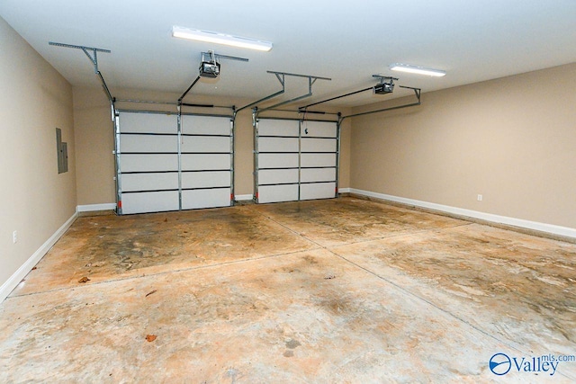 garage with a garage door opener and baseboards