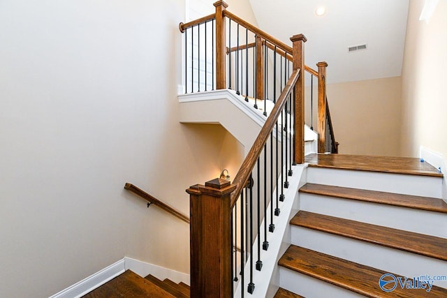 staircase with visible vents and baseboards