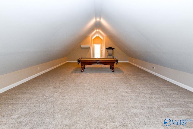 interior space featuring a wall mounted air conditioner, carpet flooring, vaulted ceiling, and baseboards