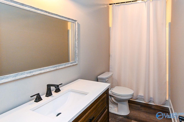 bathroom featuring toilet, shower / bathtub combination with curtain, wood finished floors, and vanity