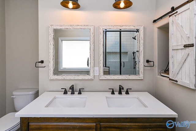 full bath featuring double vanity, a sink, and toilet