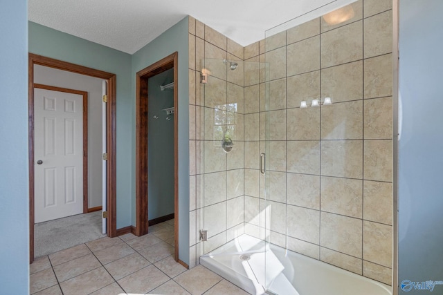 bathroom with tile patterned floors, independent shower and bath, and a textured ceiling