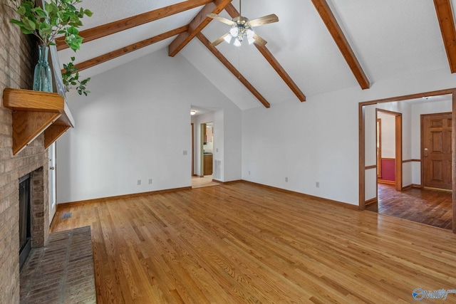 unfurnished living room with beam ceiling, a fireplace, wood-type flooring, and high vaulted ceiling