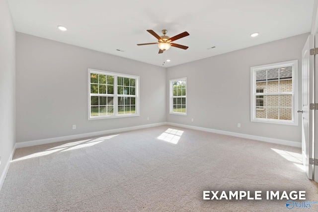 carpeted spare room with ceiling fan