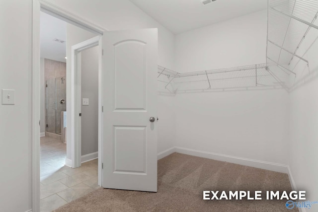 spacious closet with light tile patterned floors