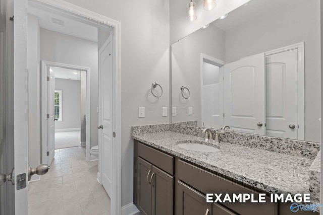 bathroom with tile patterned flooring, vanity, and toilet