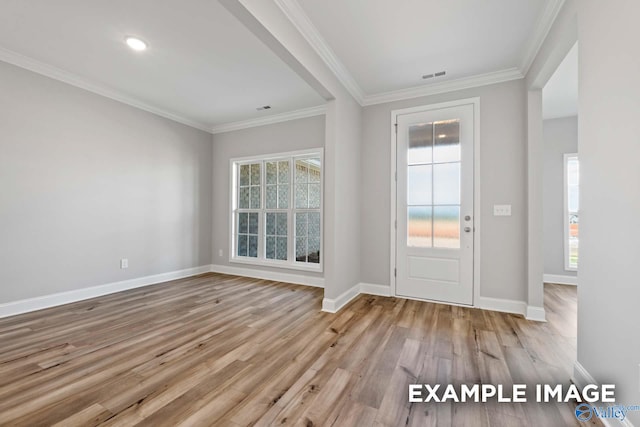 foyer entrance featuring ornamental molding and light wood-type flooring