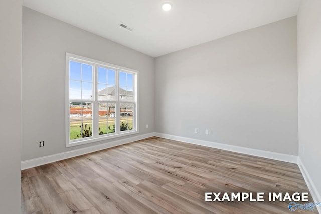 spare room with light hardwood / wood-style floors