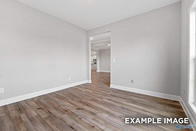 spare room with light hardwood / wood-style flooring