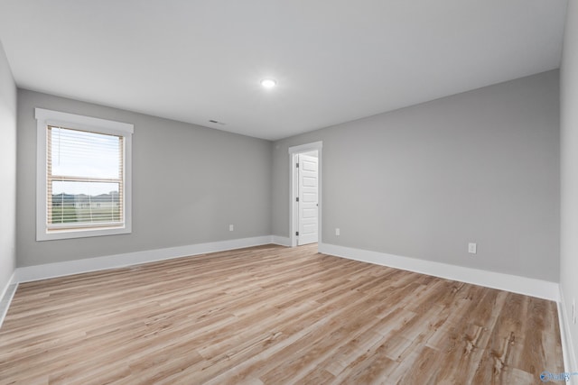 empty room with light hardwood / wood-style flooring