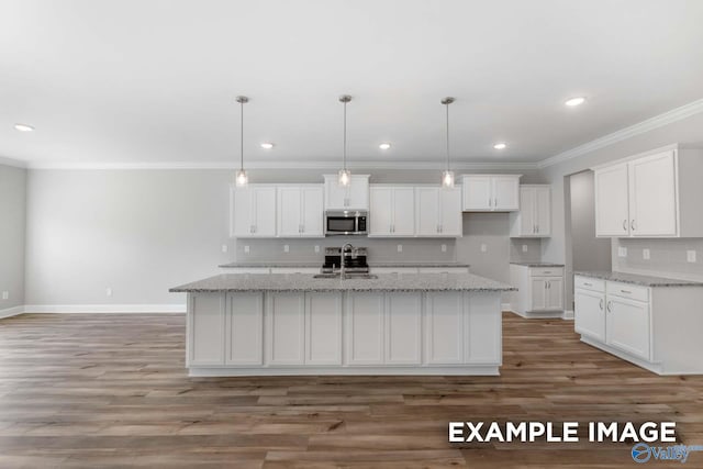 kitchen featuring white cabinets, pendant lighting, an island with sink, and sink