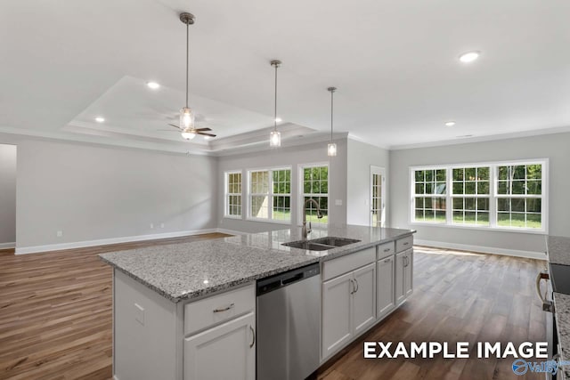 kitchen featuring a raised ceiling, sink, stainless steel dishwasher, ceiling fan, and white cabinetry