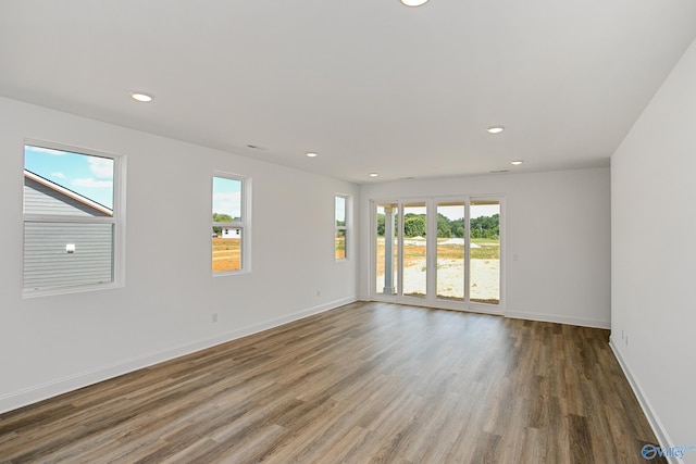 unfurnished room with dark hardwood / wood-style floors