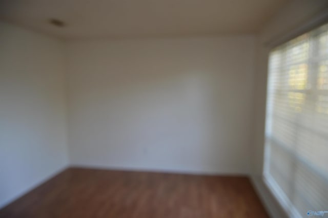 empty room with hardwood / wood-style flooring