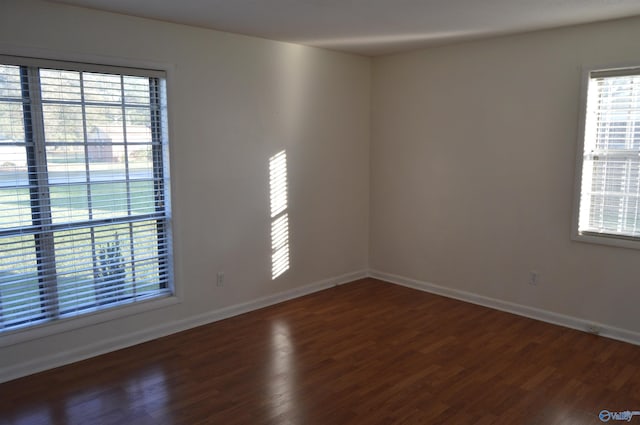 empty room featuring dark hardwood / wood-style flooring