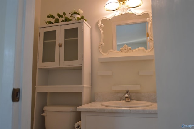 bathroom with toilet and vanity