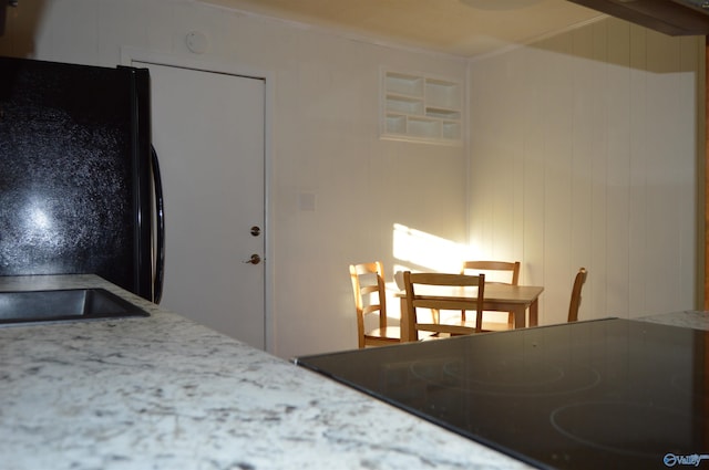 bedroom with black refrigerator