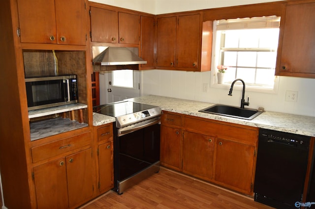 kitchen featuring stainless steel appliances, ventilation hood, plenty of natural light, and light hardwood / wood-style flooring