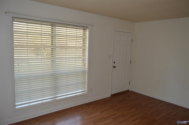 empty room with dark hardwood / wood-style floors