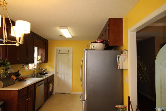 207 Brook Wind Dr, Hazel Green, AL 35750 - kitchen featuring light floors, stainless steel appliances, light countertops, a sink, and baseboards