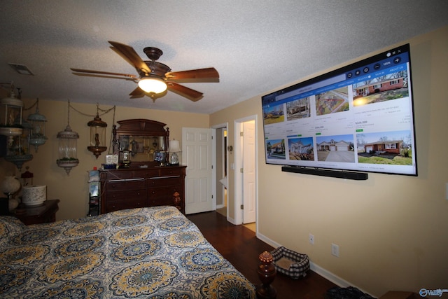 207 Brook Wind Dr, Hazel Green, AL 35750 - bedroom with dark wood-style floors, ceiling fan, visible vents, baseboards, and a textured ceiling