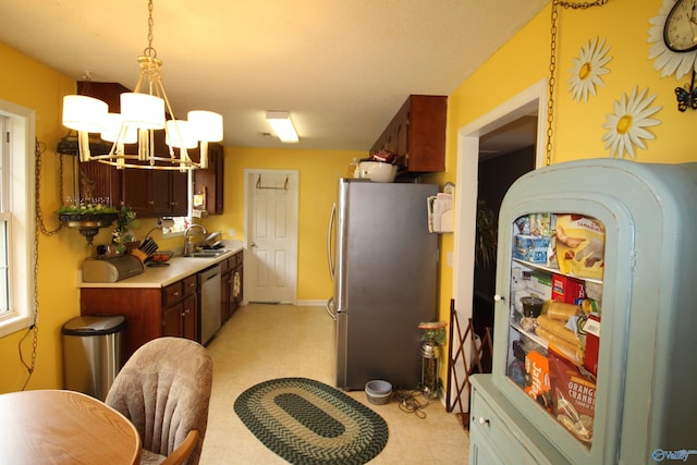 207 Brook Wind Dr, Hazel Green, AL 35750 - kitchen featuring light floors, an inviting chandelier, appliances with stainless steel finishes, light countertops, and a sink
