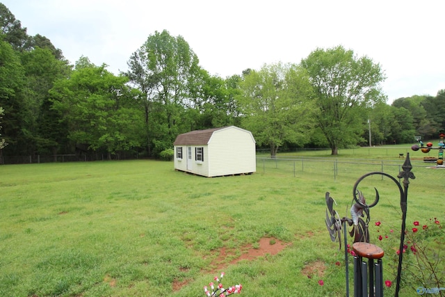 207 Brook Wind Dr, Hazel Green, AL 35750 - view of yard with a storage unit, fence, and an outbuilding