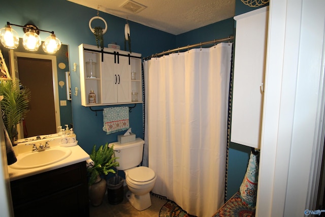 207 Brook Wind Dr, Hazel Green, AL 35750 - full bath with a shower with shower curtain, toilet, vanity, visible vents, and a textured ceiling