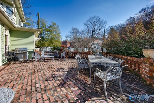 view of patio featuring area for grilling and a fireplace