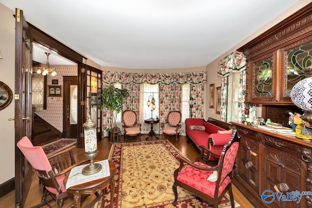 living area with a notable chandelier and wood-type flooring