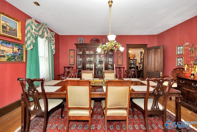 dining area with hardwood / wood-style floors