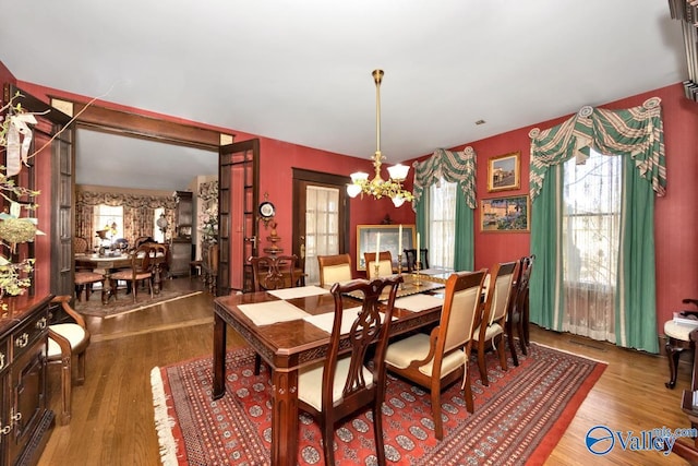 dining room featuring an inviting chandelier and wood-type flooring