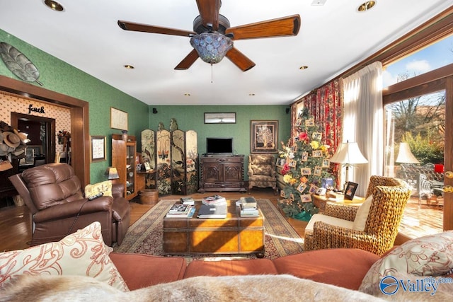 living room featuring wood-type flooring and ceiling fan