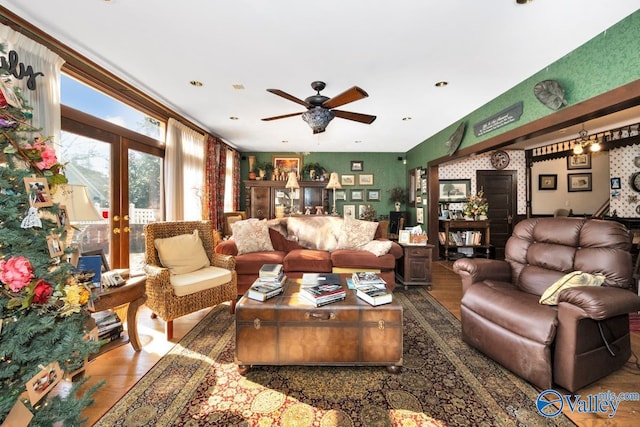 living room with wood-type flooring, ceiling fan, and french doors