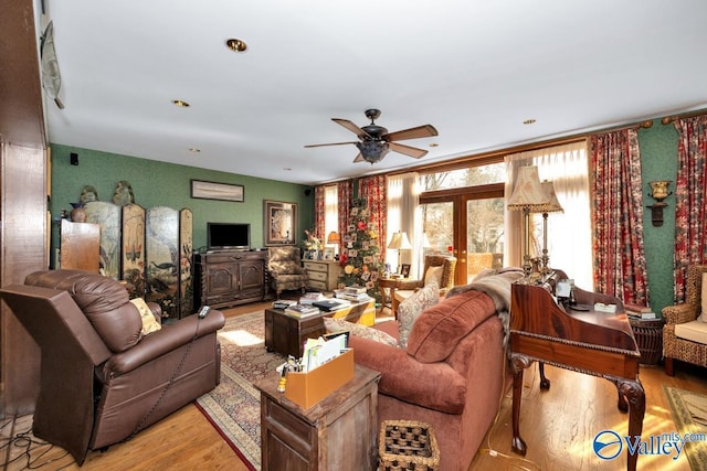 living room featuring light hardwood / wood-style flooring and ceiling fan