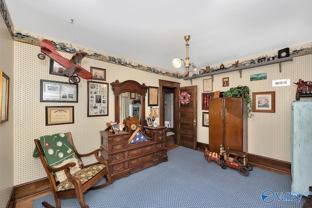 living area featuring carpet flooring and a chandelier
