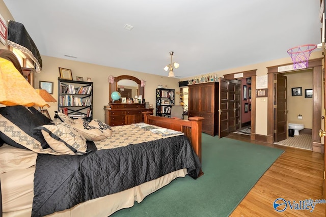 bedroom with hardwood / wood-style flooring